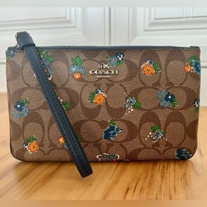Coach Wristlet with Blue Leather Strap, Signature Monogram, and Floral Print